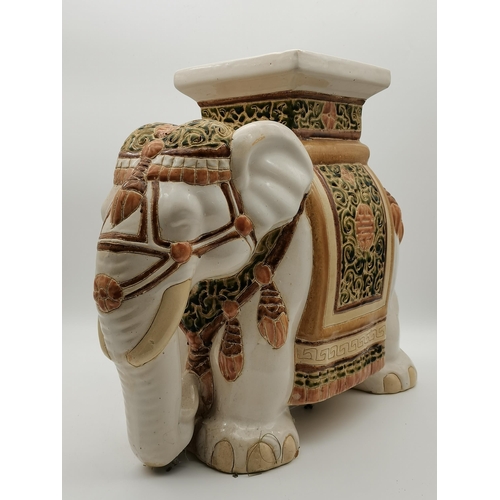 41 - A ceramic jardinière, the plant stand as an Asian elephant, cream, with green and brown decoration. ... 