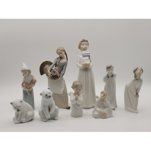 44 - A collection of porcelain figures, Lladro and Nao, including two polar bears, a young woman holding ... 