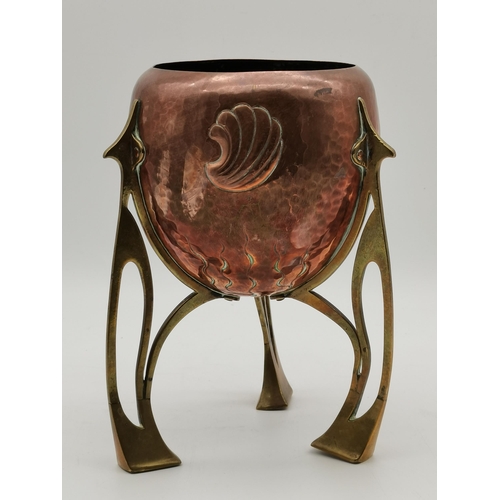 52 - An Art Nouveau copper and brass small jardinière, c.1910, rocket form, the ovoid copper planter repo... 