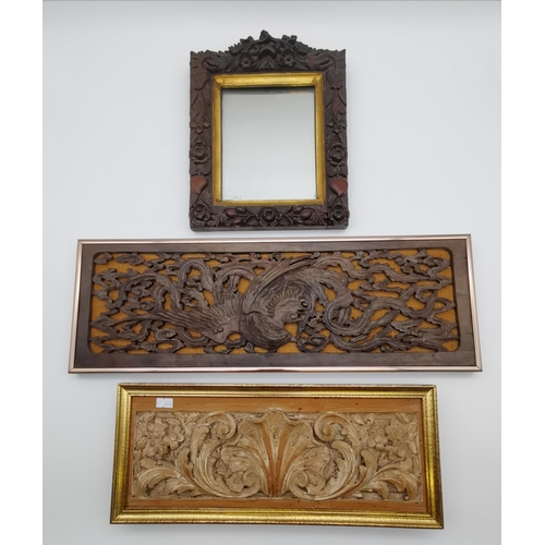 54 - A small wall mirror, the wooden frame profusely carved with flowers, foliage and fruits; together wi... 