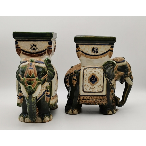 56 - A near pair of small ceramic jardinières, the plant stands as green Asian elephants with cream, blue... 