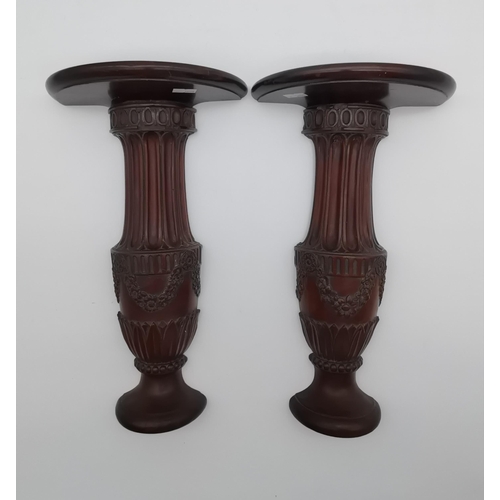 69 - A pair of mahogany carved wall brackets, each as a fluted column issuing from an urn base adorned wi... 