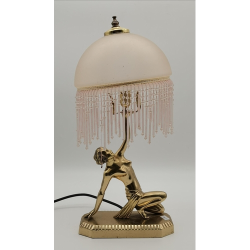 71 - An Art Deco style brass table lamp, modelled as a semi-nude female on a rectangular plinth holding a... 