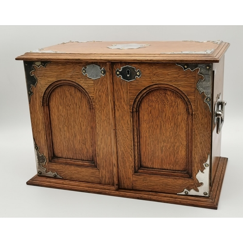 75 - An oak smoker's cabinet with white-metal mounts and twin handles, early 20th Century, presentation i... 