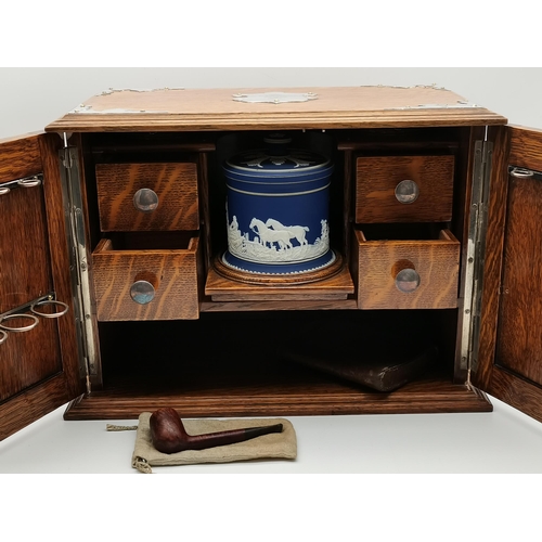 75 - An oak smoker's cabinet with white-metal mounts and twin handles, early 20th Century, presentation i... 