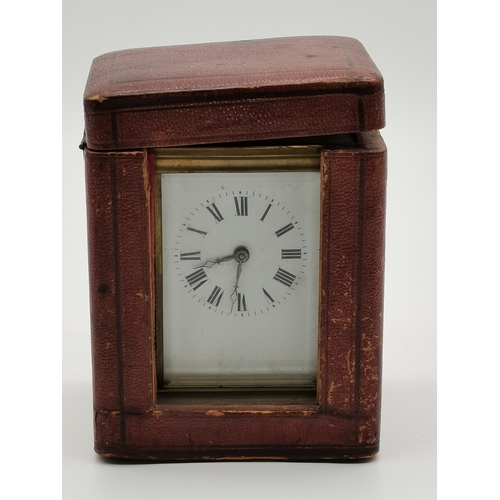 81 - A brass carriage clock, unsigned, with black Roman numerals, the movement stamped A.C.C. / L., the b... 