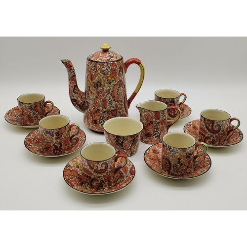 82 - A Winton 'Paisley' coffee service comprising coffee pot, six coffee cans and saucers, sugar bowl and... 