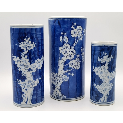 86 - A trio of graduated Chinese blue and white cylindrical vases, decorated with prunus. (3) Largest 28c... 