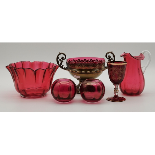 87 - A small group of assorted cranberry glass wares comprising a fluted bowl, baluster jug, pair of smal... 