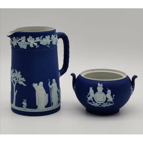 95 - A small collection of Wedgwood blue jasperware, including a royal blue twin-handled jar with GR VI c... 