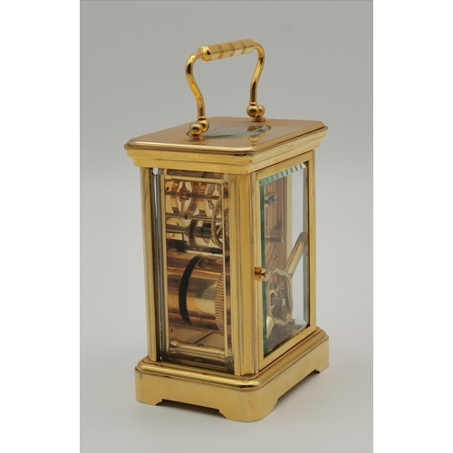 97 - A brass carriage clock, the gilt dial signed HALCYON DAYS ENAMELS and decorated with peacocks, with ... 