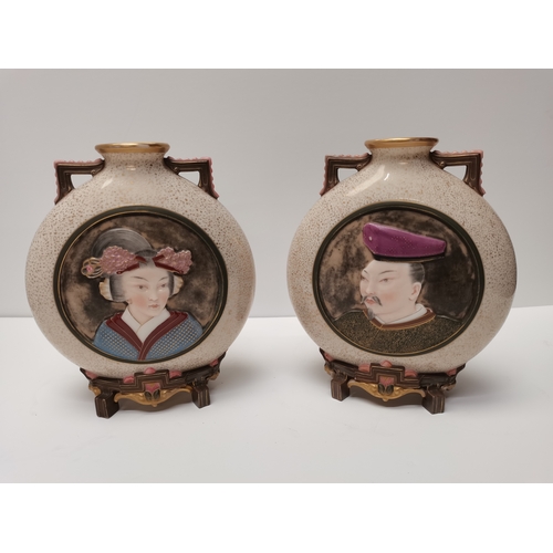 214 - A pair of Royal Worcester porcelain Japanese style moon flask vases, late 19th Century, with speckle... 