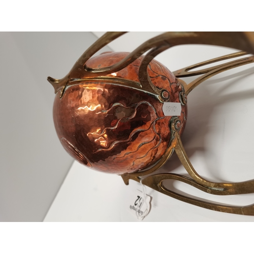 52 - An Art Nouveau copper and brass small jardinière, c.1910, rocket form, the ovoid copper planter repo... 