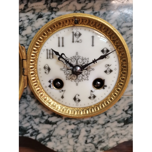 57 - A French marble mantel clock, the circular cream dial with black Arabic numerals, the case surmounte... 