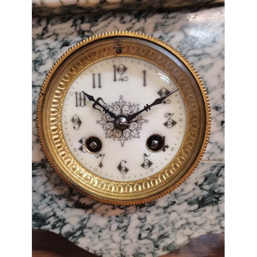 57 - A French marble mantel clock, the circular cream dial with black Arabic numerals, the case surmounte... 