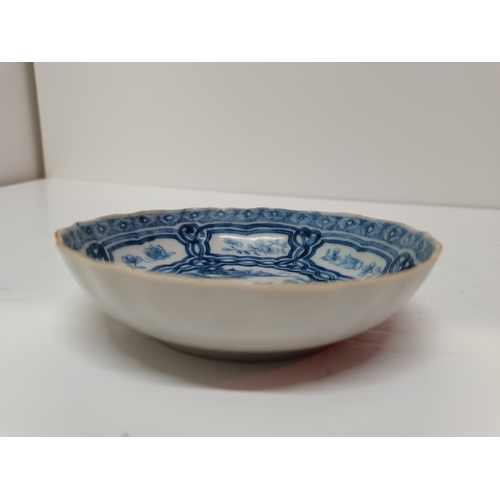 176 - A Chinese blue and white porcelain dish, with shaped edge, decorated to the well with a pagoda and t... 