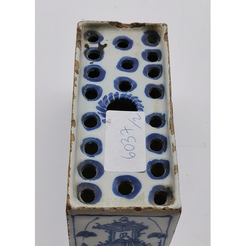 166 - A Delft blue and white flower brick, decorated with a kneeling figure and birds each side, a pagoda ... 