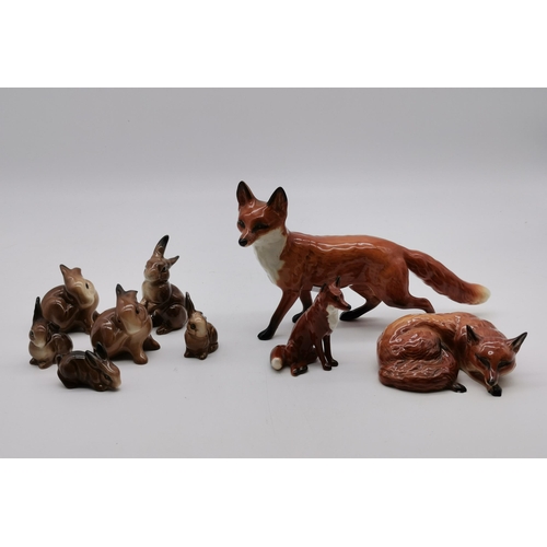 197 - A collection of Beswick animals - Standing Fox, Laying Down Fox 1019, Small sitting fox and 6 brown ... 