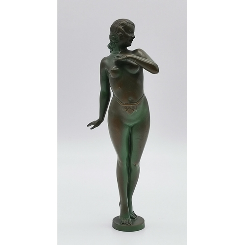 512 - A patinated metal sculpture of an Art Deco nude female, standing. 25cm high