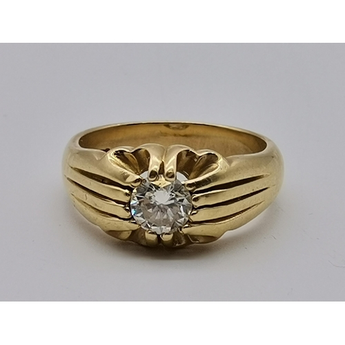 513 - A gent's 18 carat gold solitaire diamond ring, the single stone claw-set to pierced and reeded shoul... 