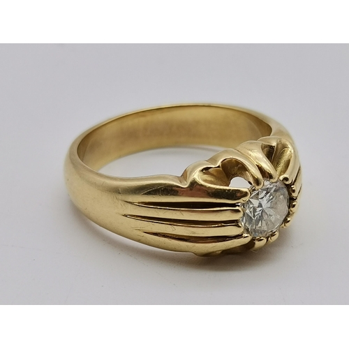 513 - A gent's 18 carat gold solitaire diamond ring, the single stone claw-set to pierced and reeded shoul... 