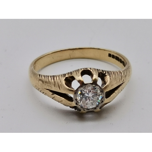 519 - A gent's 9 carat gold solitaire diamond ring, the single stone set to an openwork and split-shoulder... 