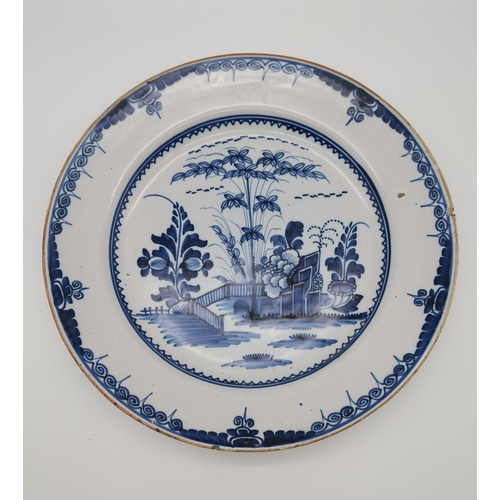 54 - A small collection of assorted blue and white ceramic wares comprising a Delft charger; an oval dish... 