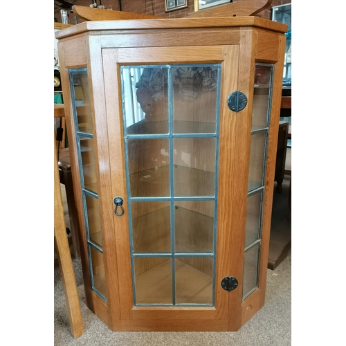 694 - Robert Thompson, a Mouseman glazed oak hanging corner cupboard, with leaded glass door and sides, th... 