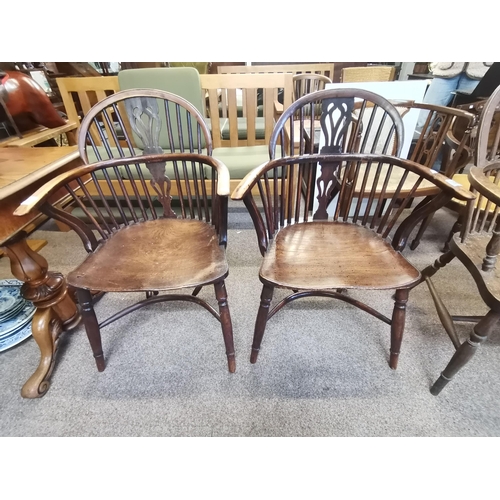 664 - A pair of Windsor yew wood arm chairs with crinoline stretchers ( 1 d/d)