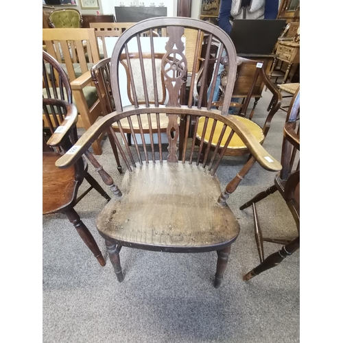 665 - A Windsor chair with unusual curved arms and stick back with turned stretcher