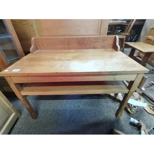 696 - A Yorkshire oak low serving table with raised back, rectangular, with shallow shelf below, raised on... 