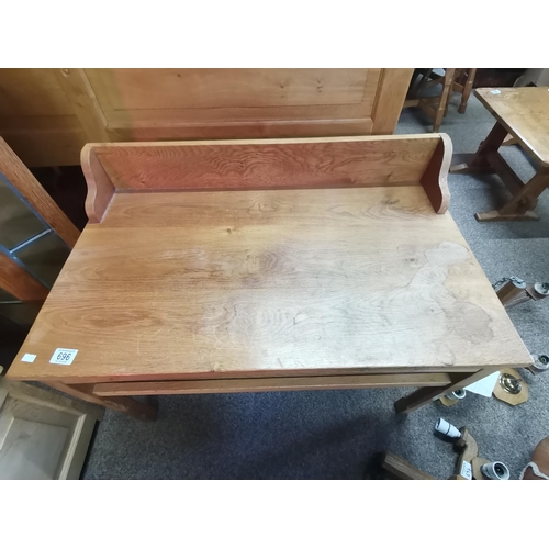 696 - A Yorkshire oak low serving table with raised back, rectangular, with shallow shelf below, raised on... 