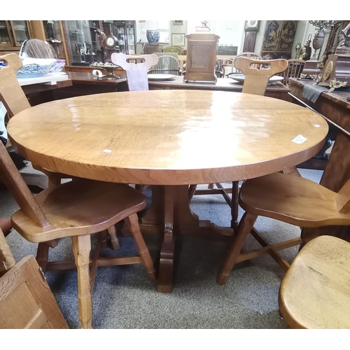 705 - Don Craven, a Foxman oak dining table, the adzed circular top raised on a cruciform base, with carve... 