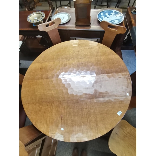 705 - Don Craven, a Foxman oak dining table, the adzed circular top raised on a cruciform base, with carve... 