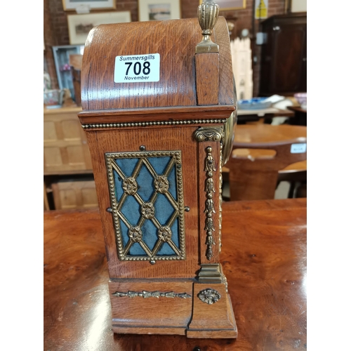 708 - Oak cased mantle clock with brass detailing with key and pendulum