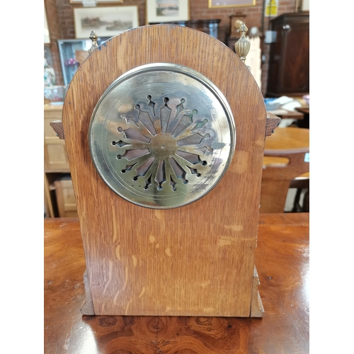 708 - Oak cased mantle clock with brass detailing with key and pendulum