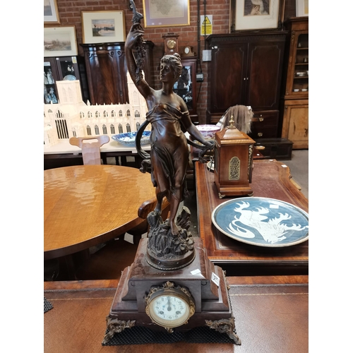 710 - A French marble and spelter clock garniture, 19th Century, the circular cream dial with black Arabic... 