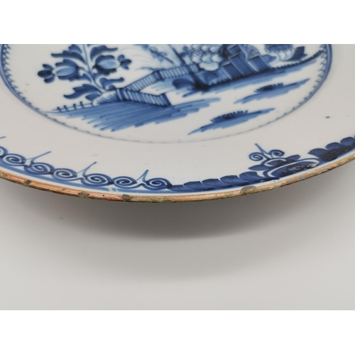 54 - A small collection of assorted blue and white ceramic wares comprising a Delft charger; an oval dish... 