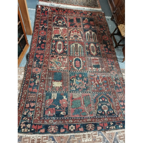 1149e - A vintage rug in blues , reds and cream with floral decorations, 2.4m x 1.4m