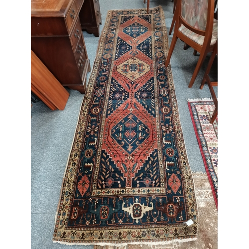 1149k - A large runner in mainly blue, red and cream highly decorated 3m x 90cm