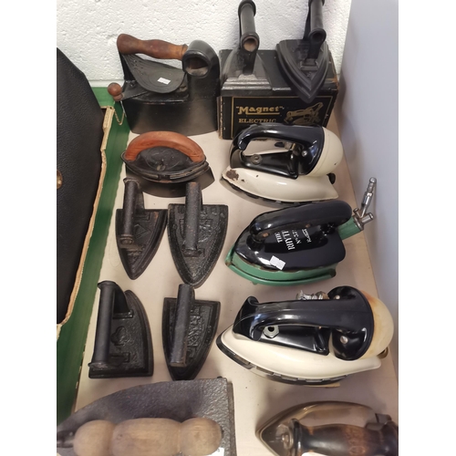 738 - Collection of vintage irons, lights and leather cases