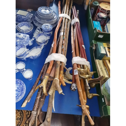 778 - x2 bundles (over 20) walking canes and sticks, some with bone handles and brass animal heads