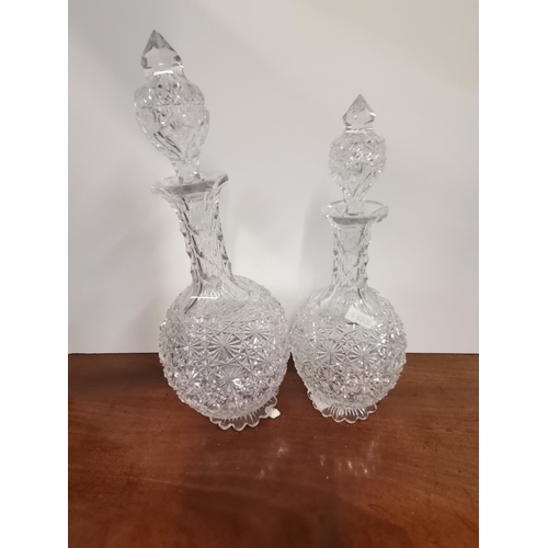 667 - Two antique cut-glass decanters, the finely star-cut globular bodies with slender faceted necks, con... 