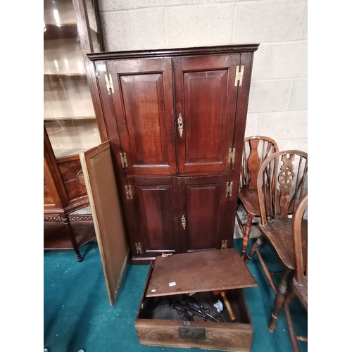 863 - Antique Oak four panelled cupboard with brass fittings W83cm x H143cm x D49cm and bevelled wall mirr... 