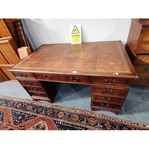 1176 - A pedestal mahogany writing desk with brown leathered top 1.5m x 90cmCondition StatusGood: In good c... 