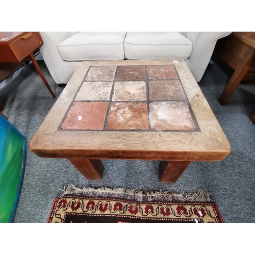 1162 - A retro style oak and terracotta tiled finish coffee table 70cm x 70cm x H43cm