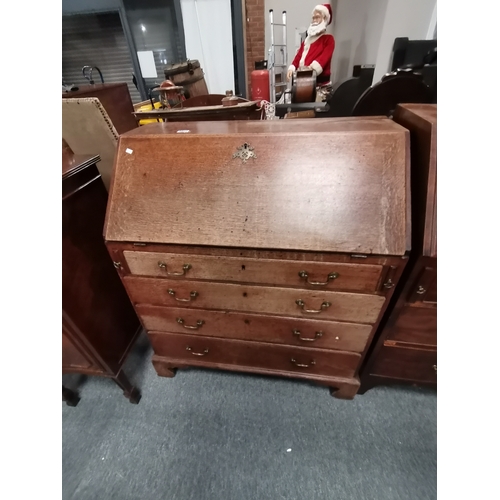 1215 - A Georgian oak 4 drawer bureau Condition StatusGood: In good condition overall, but possibly some or... 