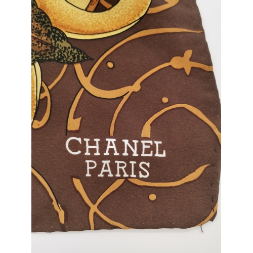 335 - A vintage Chanel silk scarf, sunflower and autumnal leaves pattern to a brown ground, c.1990s, CHANE... 