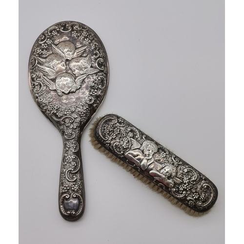 394 - A Victorian silver backed hand mirror and clothes brush by John Newton Mappin (Mappin & Webb), Londo... 