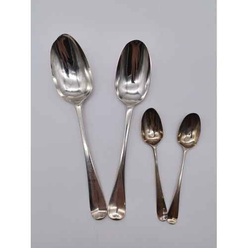 425 - Four assorted silver spoons, comprising a Queen Anne/George I Britannia standard table spoon, maker'... 